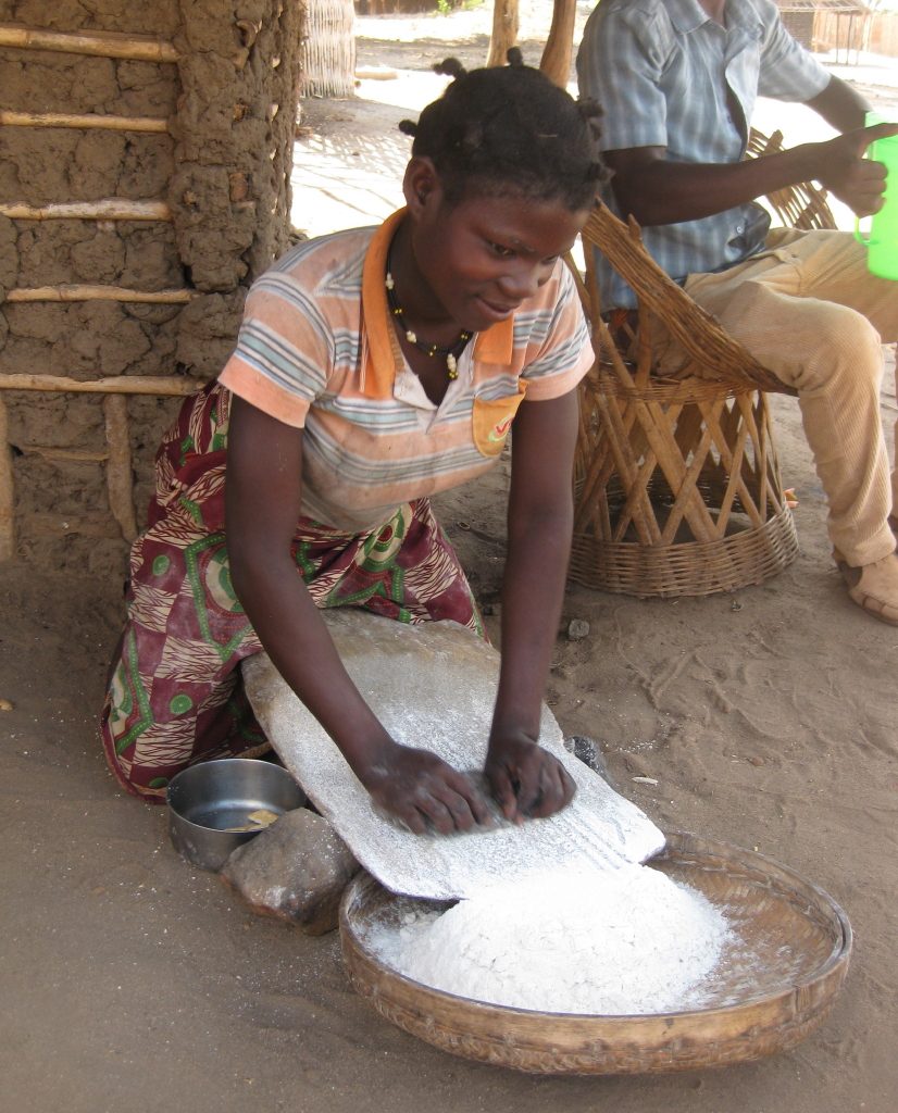 Grain being milled by hand between stones