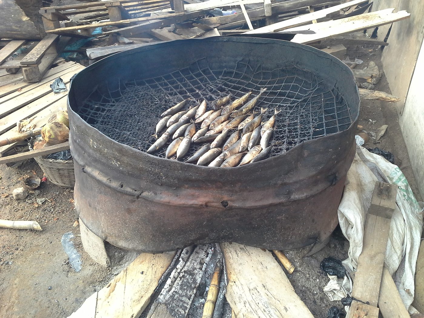 A masonry firebox stove of the type used under stacked fish smoking trays