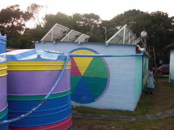 Rainwater harvesting tanks plumbed to a building's downpipes in South Africa