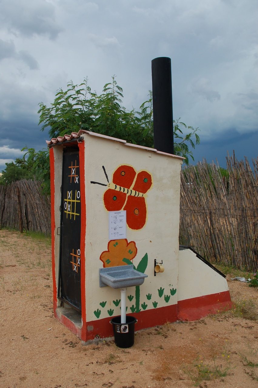 A urine-diverting dry toilet block with vent pipes and external vault access