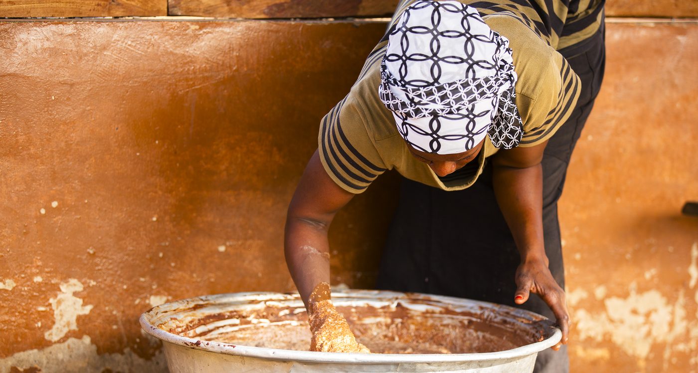 Women processing shea kernels into butter in Ghana