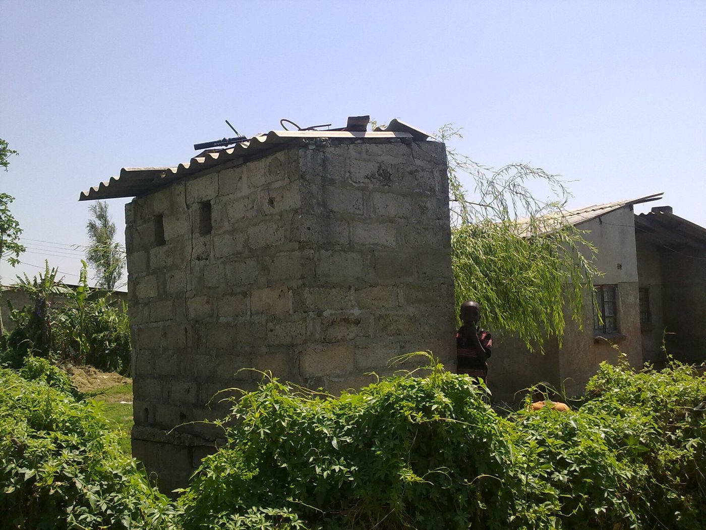 A masonry pit latrine superstructure with roof and vent stack