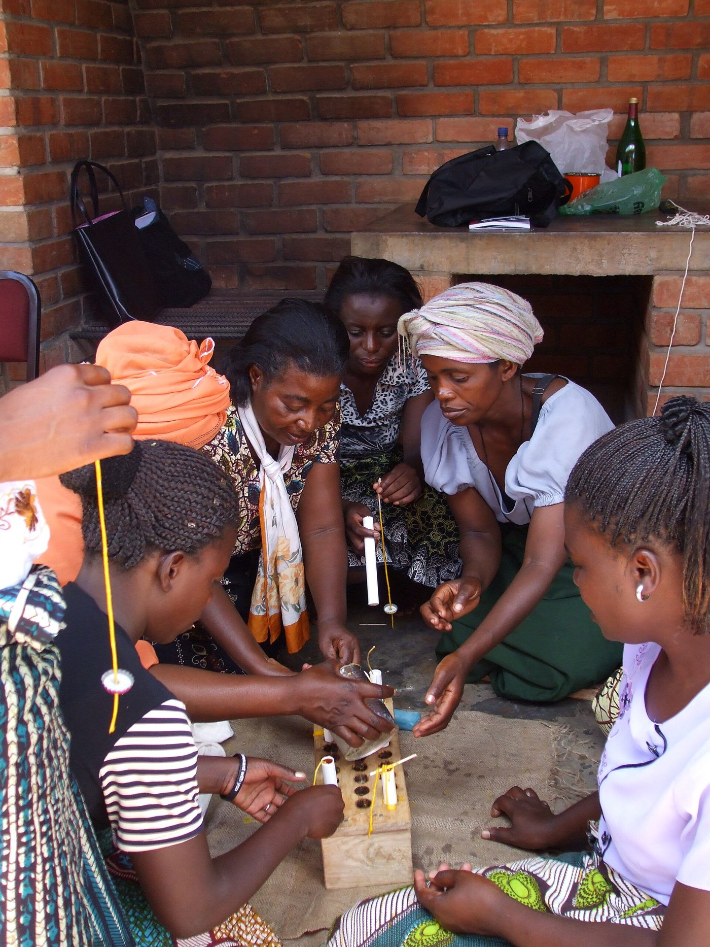 Beeswax candles being poured and rolled in Malawi
