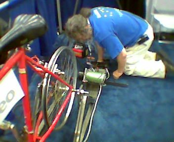 A bicycle mounted on a stand driving a small generator