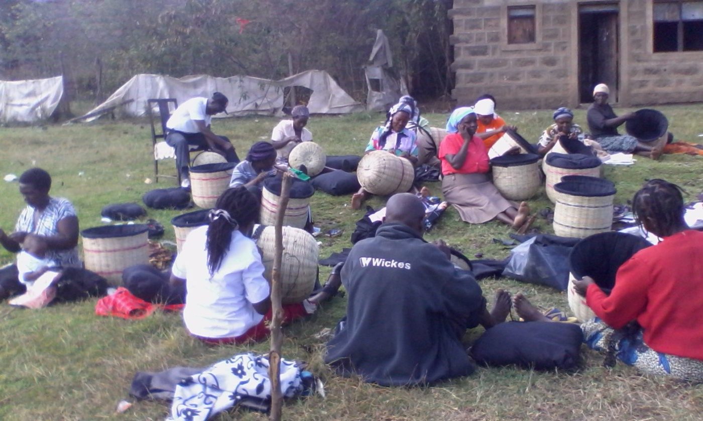 A group weaving and packing insulated baskets for fireless retained-heat cooking