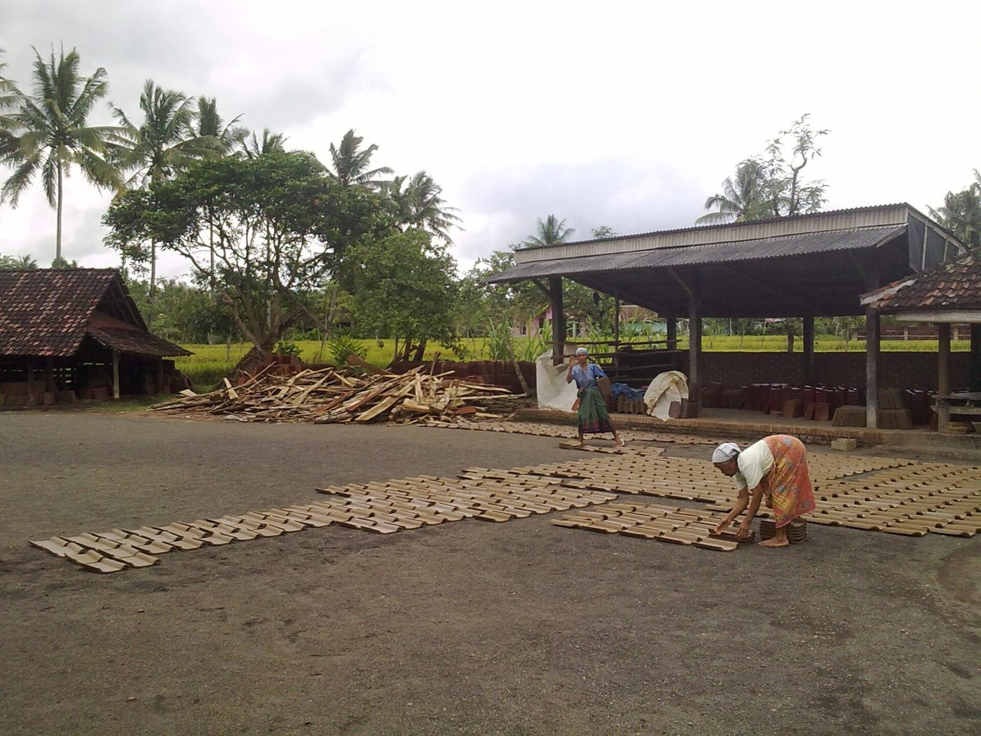 Freshly moulded concrete roof tiles laid out to cure in the yard