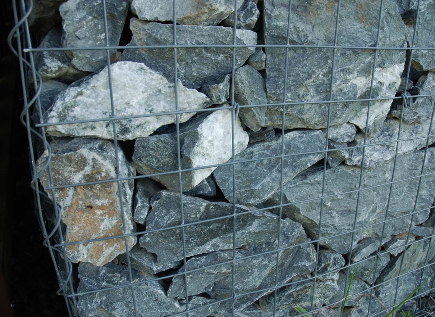 Stone-filled wire gabion baskets stacked to form a check dam