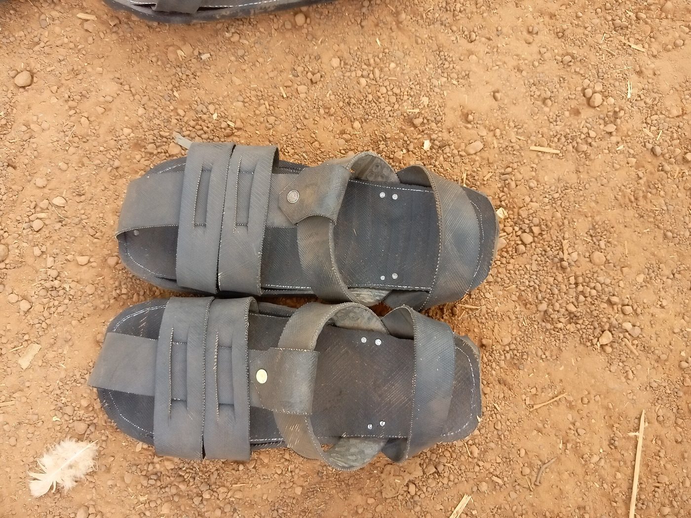 Sandals cut and stitched from an old car tyre