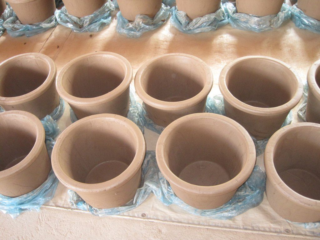Rows of fired clay filter pots waiting to be fitted into water filter buckets