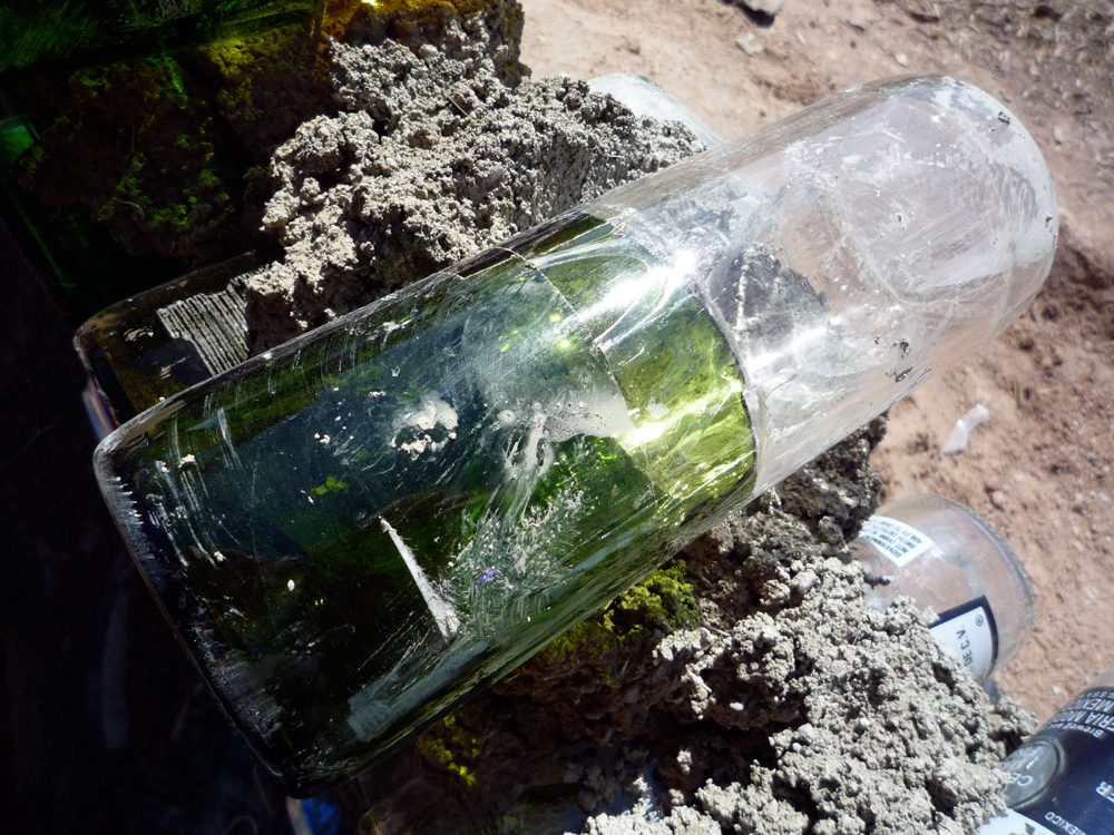 Glass bottles set in mortar forming a light-admitting infill wall panel